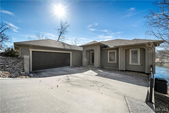 view of front of house featuring a garage and central AC unit