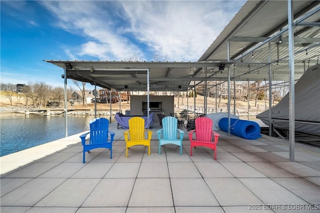 view of patio / terrace with a water view and a dock