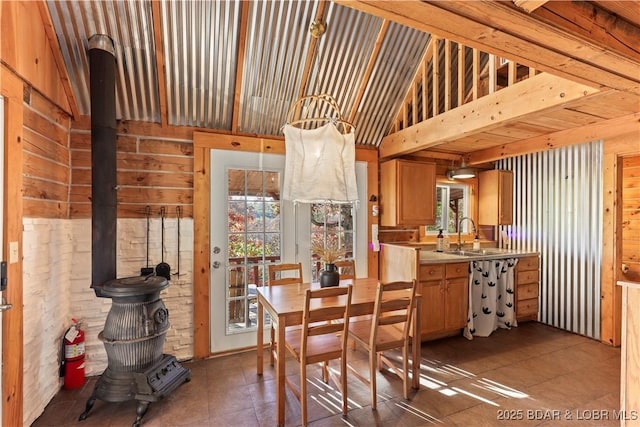 dining room with sink and high vaulted ceiling