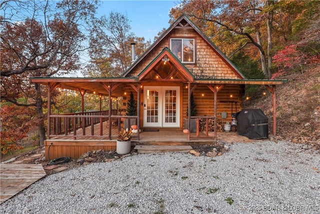 view of front of home featuring french doors and a wooden deck