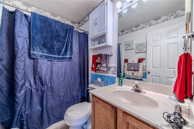 bathroom with vanity, toilet, a shower with shower curtain, and a textured ceiling