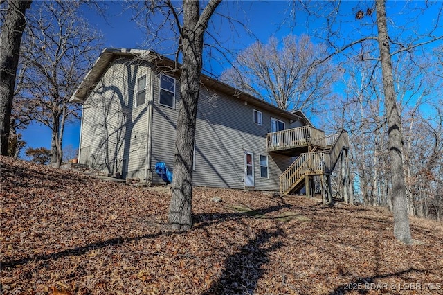 view of property exterior featuring a wooden deck