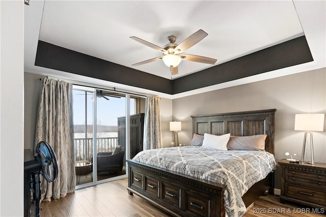 bedroom with ceiling fan, access to outside, and light hardwood / wood-style floors