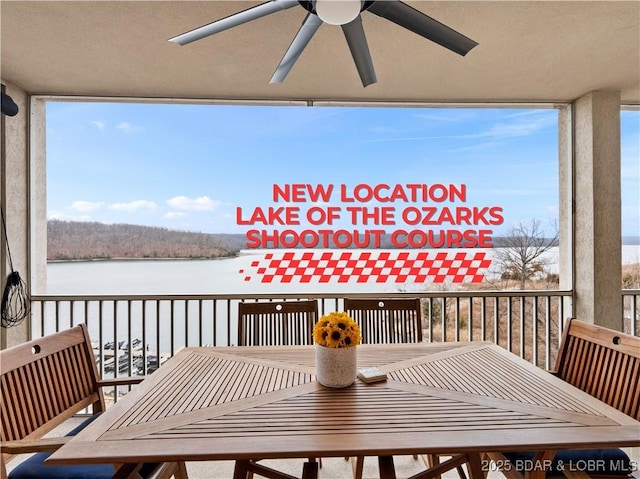 balcony with a water view and ceiling fan