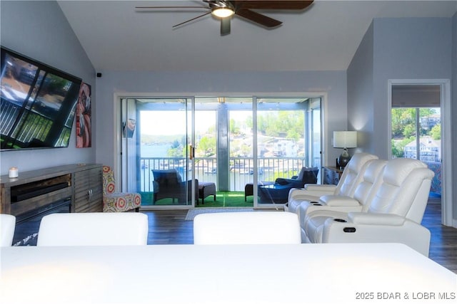 living room with lofted ceiling, plenty of natural light, dark hardwood / wood-style floors, and ceiling fan