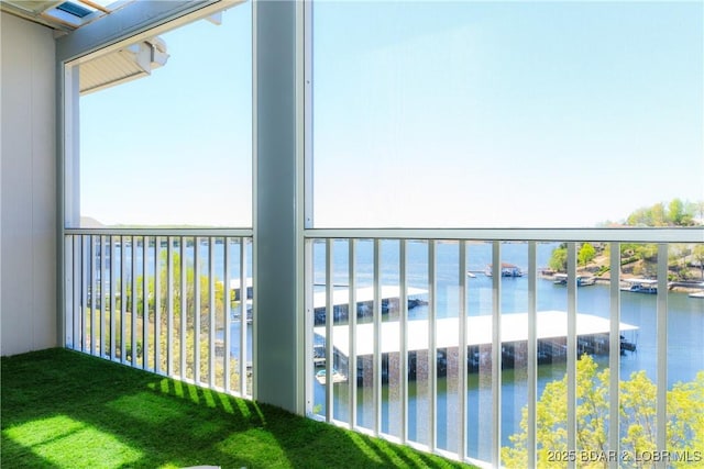 balcony featuring a beach view and a water view