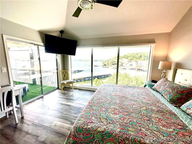 bedroom featuring hardwood / wood-style flooring, ceiling fan, access to exterior, and vaulted ceiling