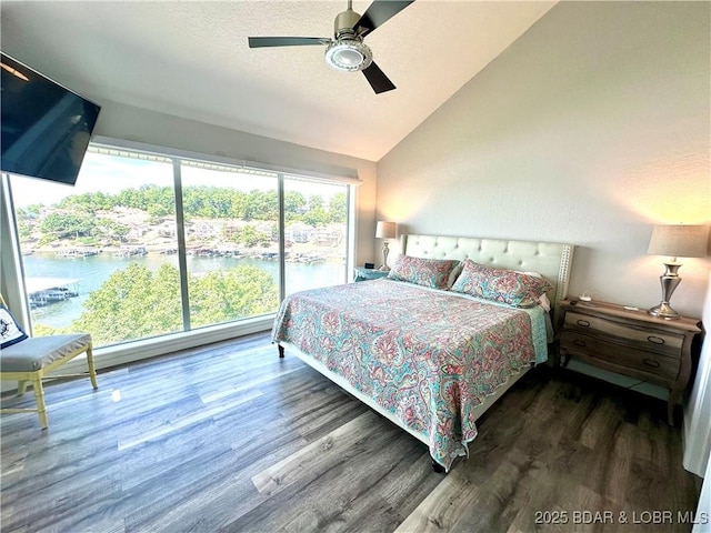 bedroom featuring vaulted ceiling, dark wood-type flooring, a textured ceiling, and ceiling fan