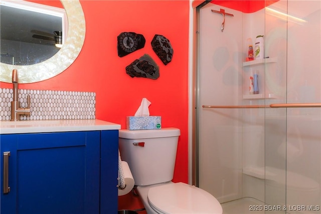 bathroom with vanity, an enclosed shower, and toilet