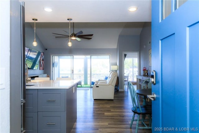 living room featuring ceiling fan, lofted ceiling, and dark hardwood / wood-style flooring