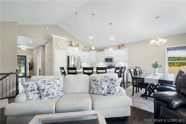 living room with dark hardwood / wood-style floors, high vaulted ceiling, and a notable chandelier