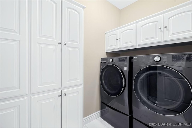 laundry area featuring cabinets and washer and dryer