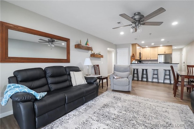 living room with hardwood / wood-style flooring and ceiling fan