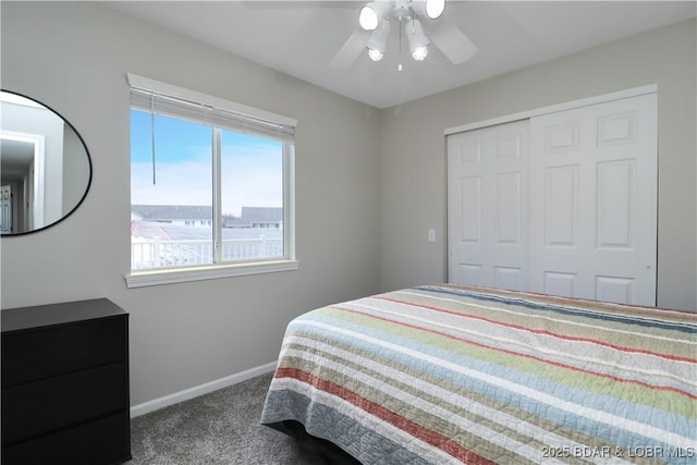 carpeted bedroom featuring ceiling fan and a closet