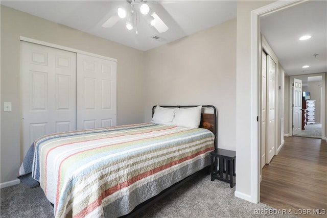 carpeted bedroom with ceiling fan and a closet