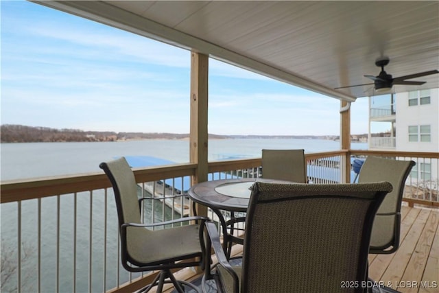 wooden terrace featuring a water view and ceiling fan