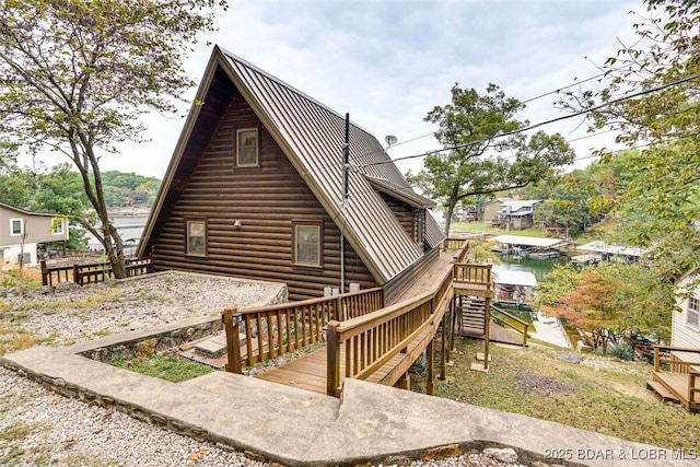 rear view of property with a water view