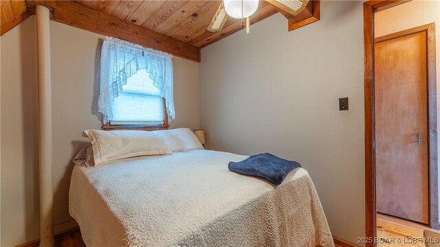 bedroom featuring wood ceiling and vaulted ceiling with beams