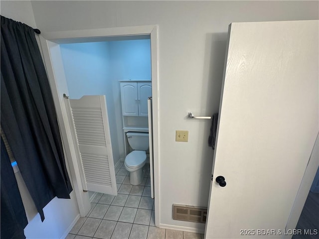223 Waterscape Dr, Osage Beach, MO 65065 - bathroom featuring toilet, tile patterned floors, and baseboards