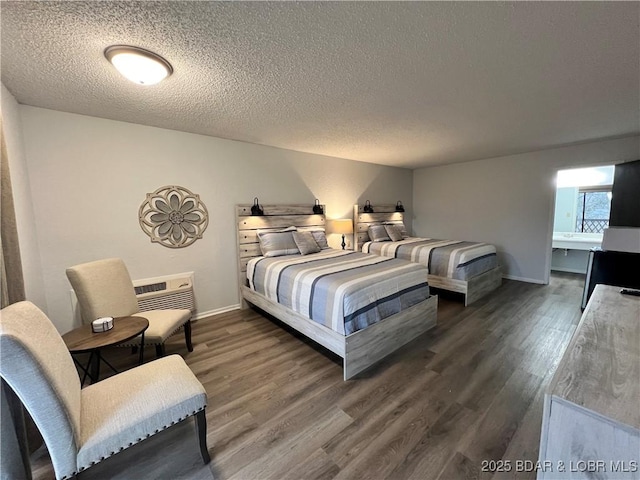 223 Waterscape Dr, Osage Beach, MO 65065 - bedroom with wood finished floors, a textured ceiling, baseboards, and an AC wall unit