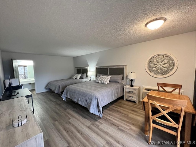 223 Waterscape Dr, Osage Beach, MO 65065 - bedroom featuring a textured ceiling and wood finished floors