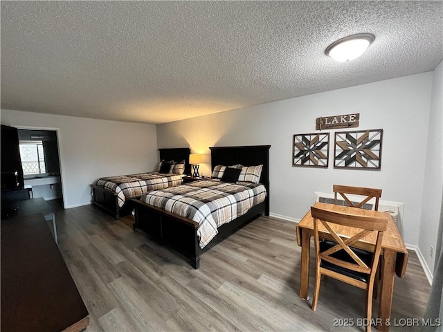223 Waterscape Dr, Osage Beach, MO 65065 - bedroom featuring a textured ceiling, wood finished floors, and baseboards