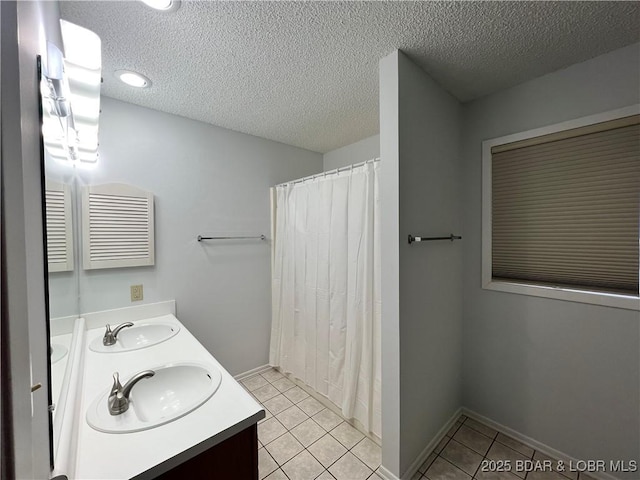 223 Waterscape Dr, Osage Beach, MO 65065 - bathroom featuring tile patterned flooring, double vanity, a textured ceiling, baseboards, and a shower with curtain