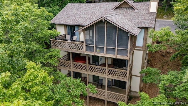 223 Waterscape Dr, Osage Beach, MO 65065 - back of property with a shingled roof, a sunroom, stucco siding, and a chimney
