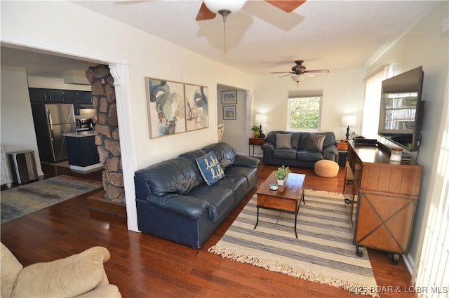 living room featuring ceiling fan and dark hardwood / wood-style floors