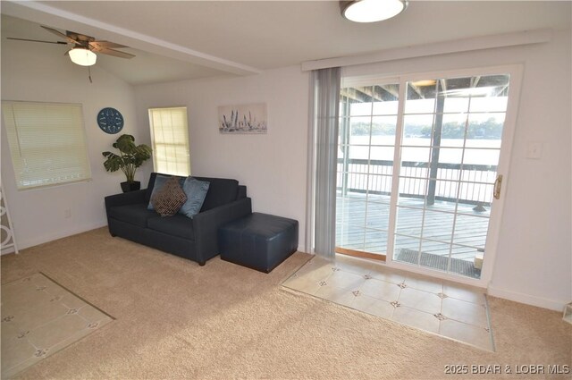 carpeted living room featuring vaulted ceiling and ceiling fan