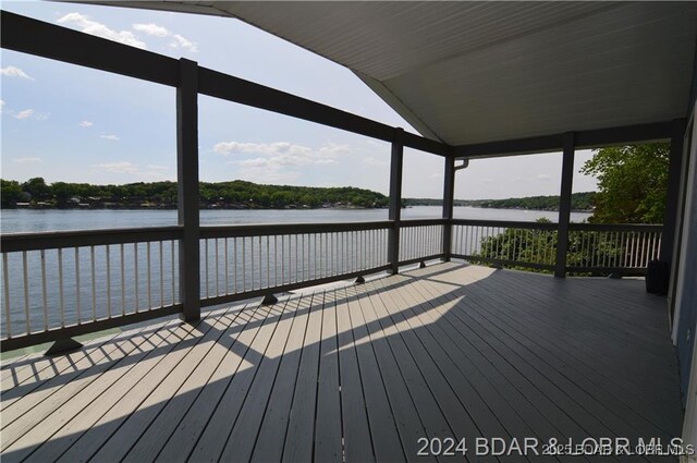 wooden terrace featuring a water view