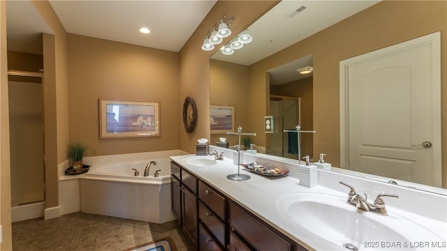 bathroom with vanity and a tub