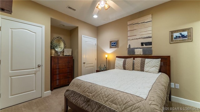 bedroom with light colored carpet and ceiling fan