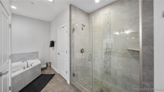 bathroom with tile patterned flooring and independent shower and bath