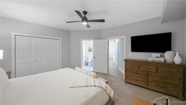 bedroom with light colored carpet, a closet, and ceiling fan