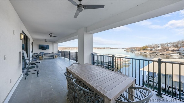 balcony with an outdoor living space and ceiling fan