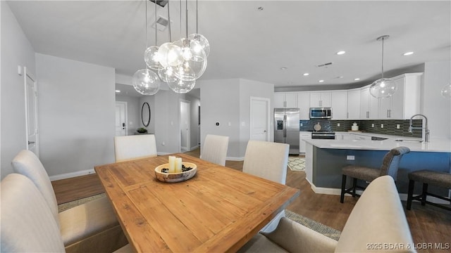 dining room featuring sink and dark hardwood / wood-style floors