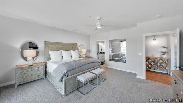 carpeted bedroom with ceiling fan and ensuite bathroom