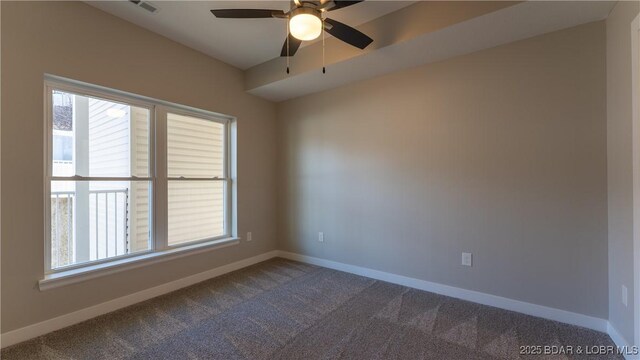 carpeted spare room featuring ceiling fan