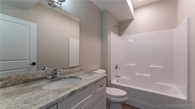 full bathroom featuring vanity, shower / bathtub combination, and toilet