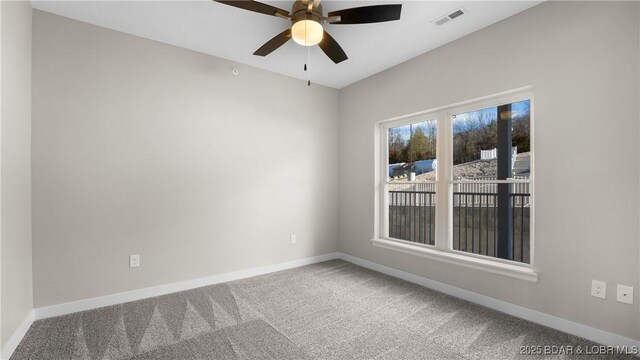 spare room with ceiling fan and carpet