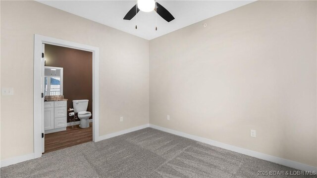 carpeted empty room featuring ceiling fan