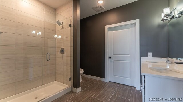 bathroom with vanity, walk in shower, and toilet