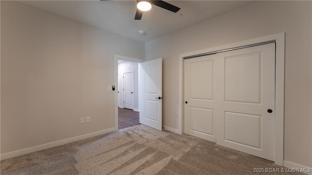 unfurnished bedroom featuring light colored carpet, a closet, and ceiling fan