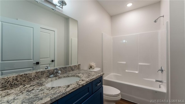 full bathroom with vanity, tub / shower combination, and toilet