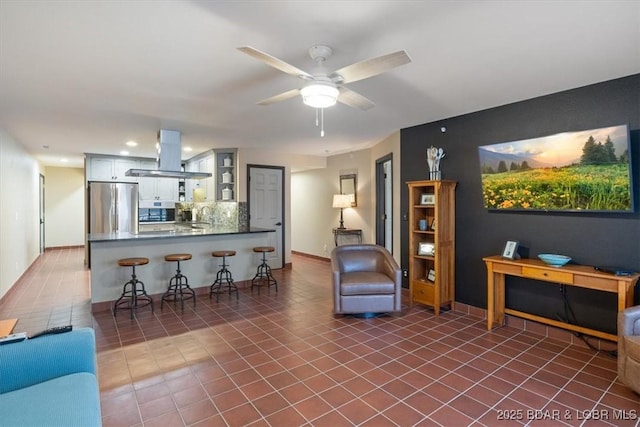 tiled living room featuring ceiling fan