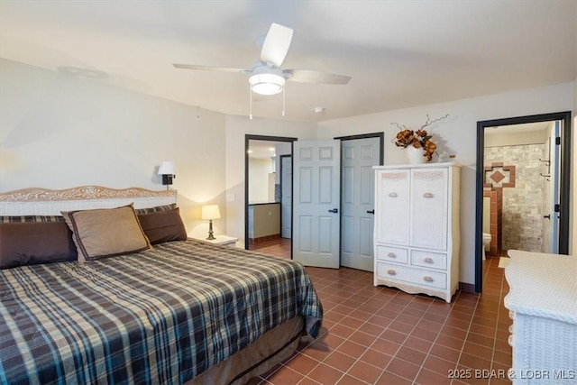 bedroom with ceiling fan and dark tile patterned floors