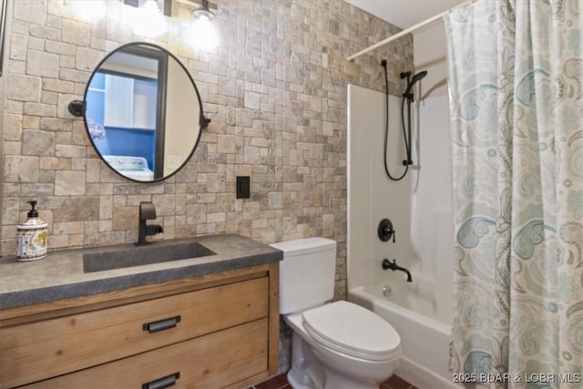 full bathroom featuring tile walls, backsplash, vanity, toilet, and shower / bath combo with shower curtain