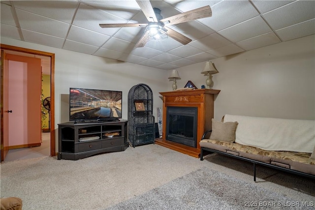 living room with carpet floors, a drop ceiling, and ceiling fan