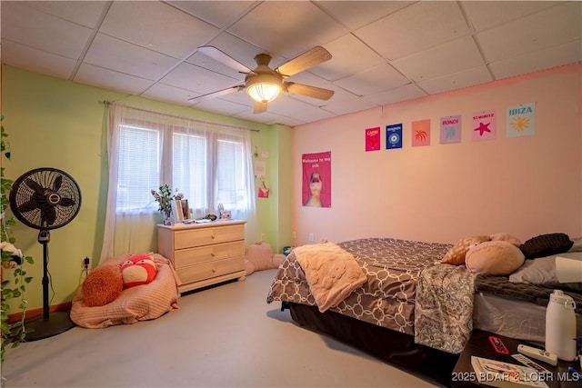 bedroom with a drop ceiling and ceiling fan